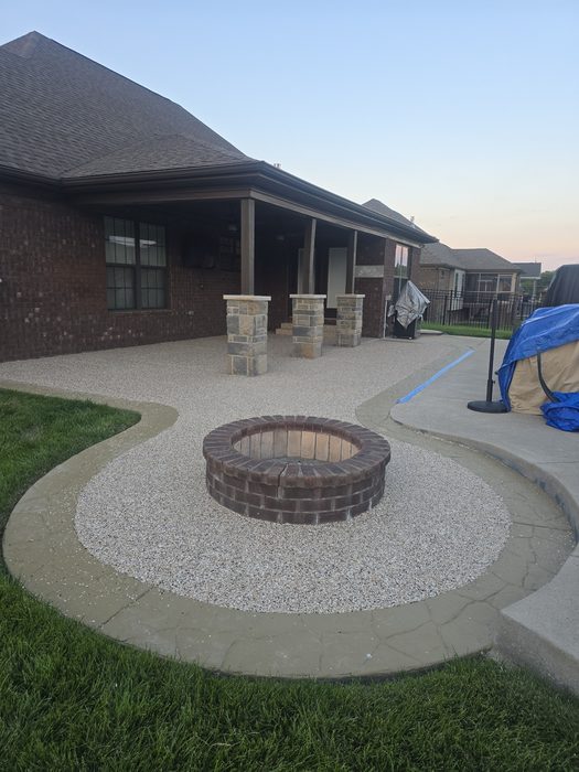 Coated concrete fire pit patio and walkway at dusk