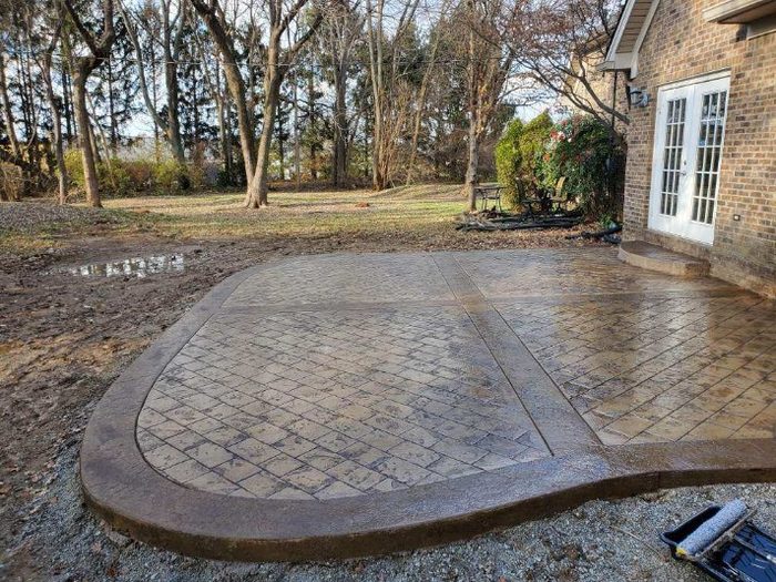 Stamped concrete patio stained and sealed with a wet-look finish