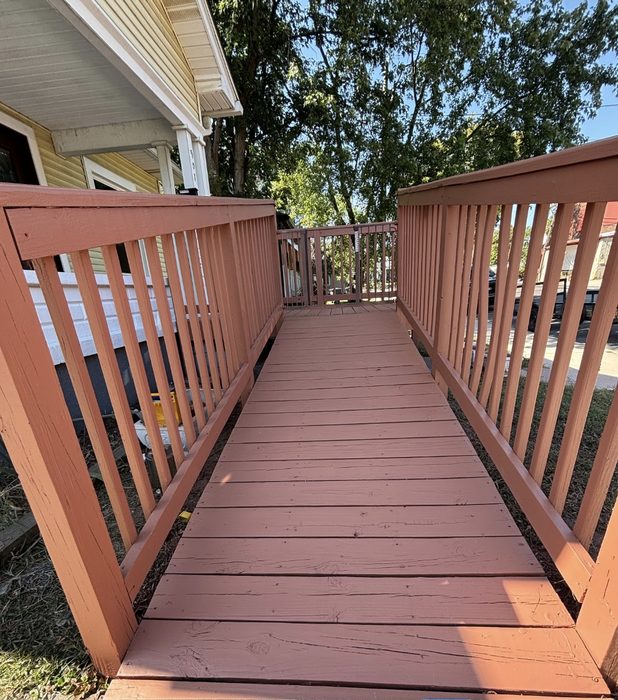 Wood wheelchair ramp and railings finished in a terracotta stain